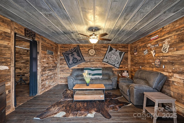 unfurnished living room featuring ceiling fan, wood ceiling, dark hardwood / wood-style flooring, and wood walls