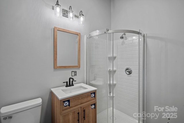 bathroom with vanity, toilet, and walk in shower