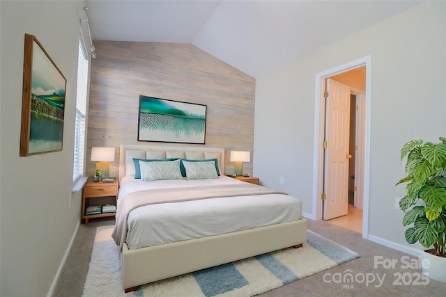 carpeted bedroom featuring lofted ceiling and wooden walls