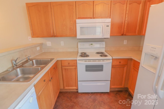 kitchen featuring sink, white appliances, and dark tile patterned floors