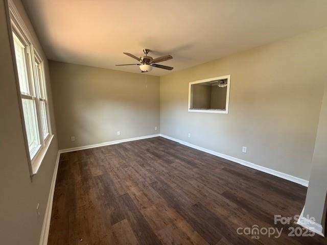 unfurnished room with dark hardwood / wood-style floors and ceiling fan