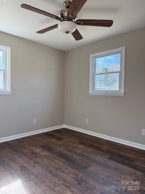 spare room with ceiling fan and dark hardwood / wood-style flooring