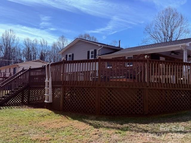 back of property featuring a lawn and a deck