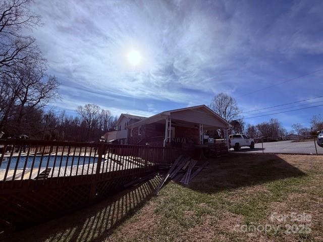 view of side of property featuring a covered pool