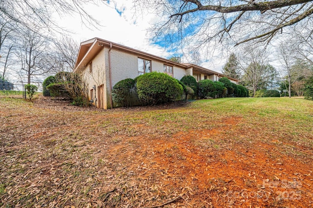 view of home's exterior featuring a yard