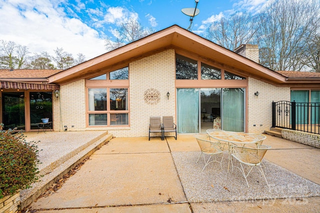 rear view of property featuring a patio area