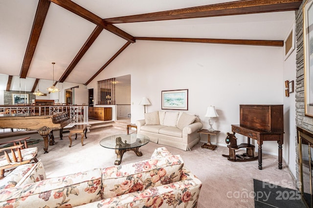 carpeted living room featuring a notable chandelier, high vaulted ceiling, a large fireplace, and beamed ceiling