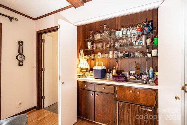 bar featuring hardwood / wood-style flooring and ornamental molding