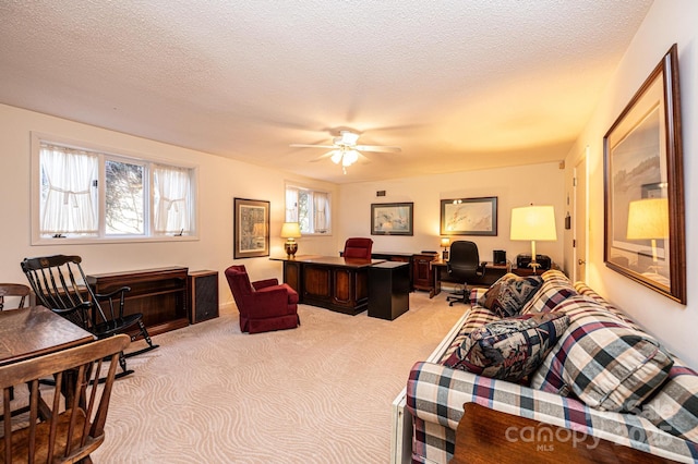 office area featuring ceiling fan, light carpet, and a textured ceiling