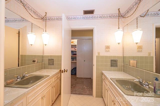 bathroom featuring tile walls, vanity, and tile patterned floors