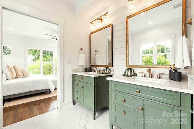 bathroom with ceiling fan and vanity