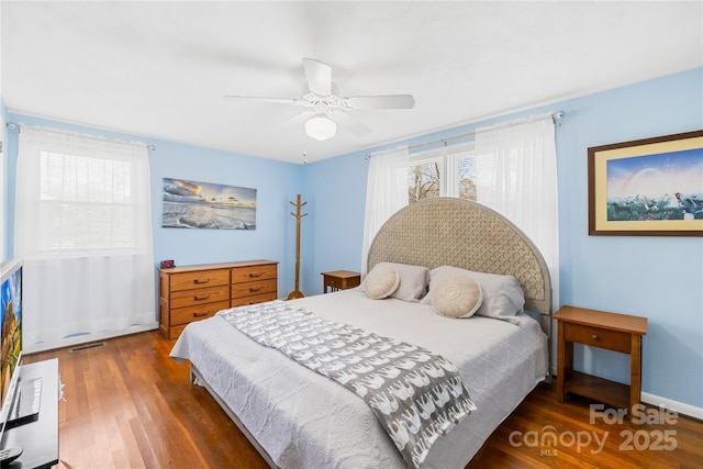 bedroom featuring ceiling fan and dark hardwood / wood-style floors