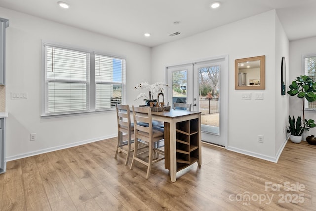 dining room featuring light wood-type flooring and french doors