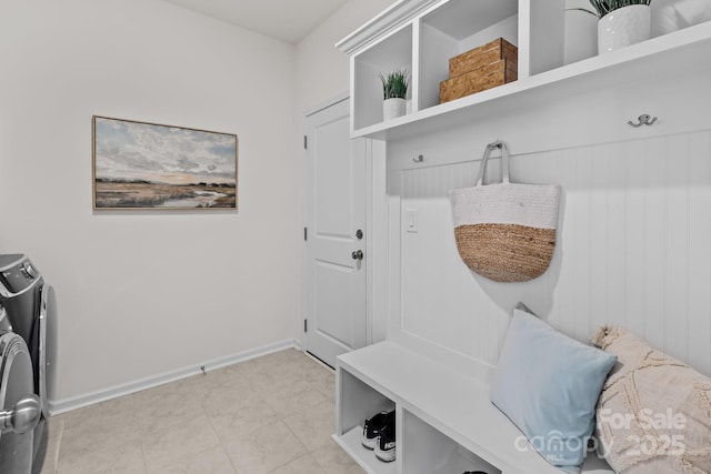 mudroom featuring washing machine and clothes dryer and light tile patterned floors