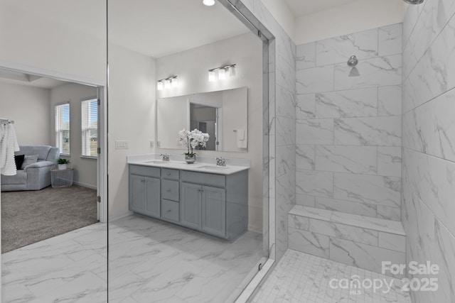 bathroom featuring vanity and tiled shower