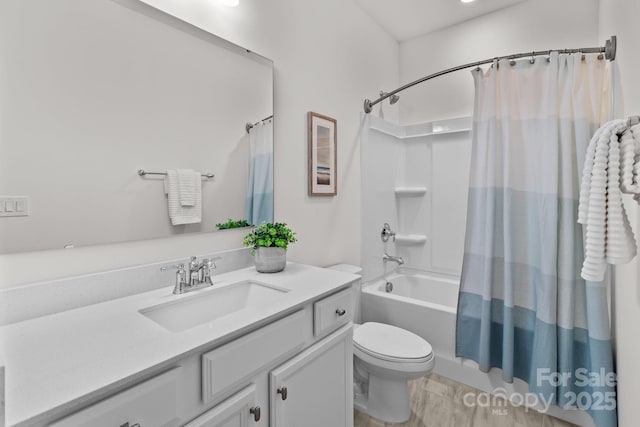 full bathroom with shower / tub combo, vanity, and toilet