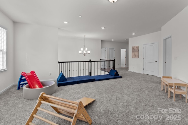 recreation room featuring carpet flooring and a chandelier