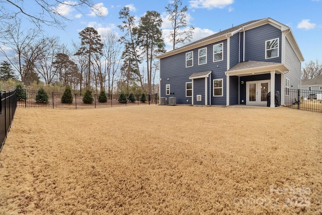 rear view of property featuring french doors and cooling unit