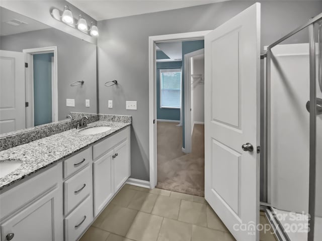 bathroom featuring tile patterned flooring, vanity, and an enclosed shower