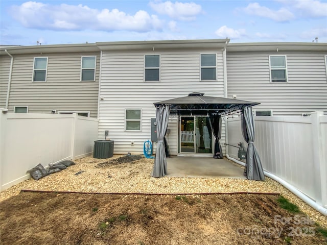 back of house featuring a gazebo, central AC unit, and a patio area