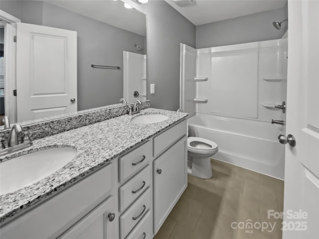 full bathroom featuring vanity, bathtub / shower combination, and toilet