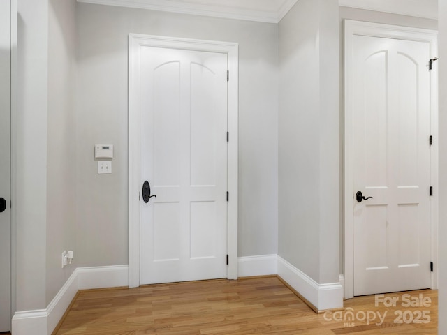 interior space with crown molding and light wood-type flooring