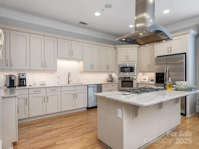 kitchen featuring island range hood, sink, ornamental molding, a center island, and stainless steel appliances