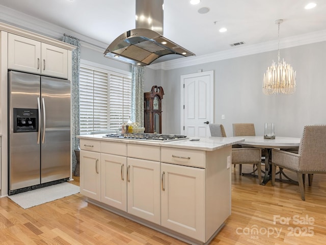 kitchen featuring a kitchen island, island exhaust hood, ornamental molding, stainless steel appliances, and light wood-type flooring