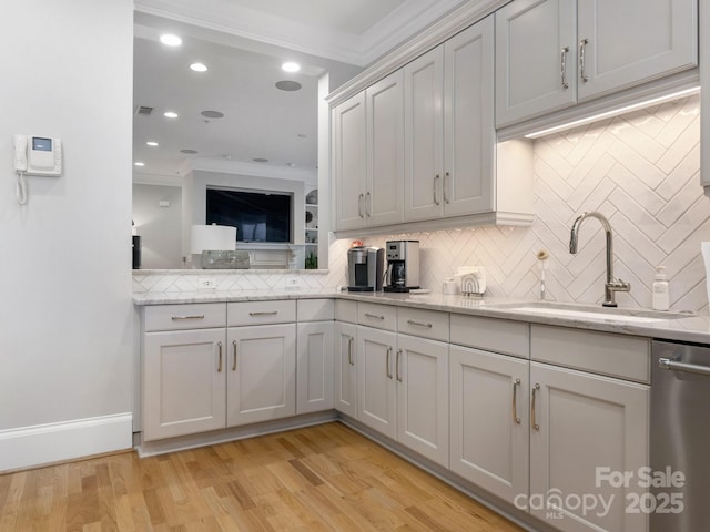 kitchen featuring dishwasher, light stone countertops, sink, and ornamental molding