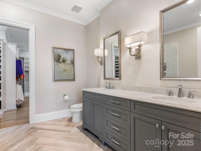 bathroom featuring vanity, parquet flooring, ornamental molding, and toilet