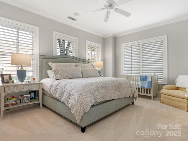 carpeted bedroom featuring crown molding and ceiling fan