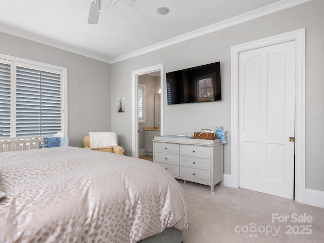 carpeted bedroom with crown molding, ceiling fan, and ensuite bathroom