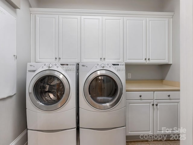 laundry area featuring independent washer and dryer and cabinets