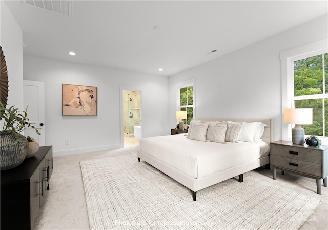 bedroom featuring multiple windows, visible vents, and light colored carpet