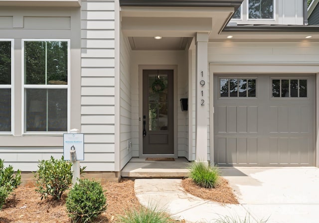 1912 St John St, Charlotte, NC 28216 - view of exterior entry with concrete driveway and a garage