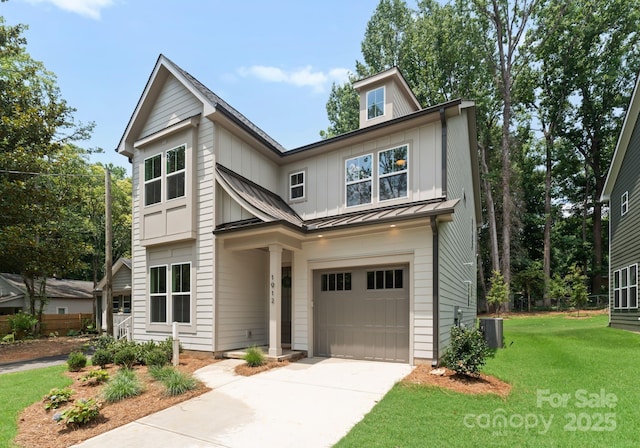 1912 St John St, Charlotte, NC 28216 - view of front of property featuring a standing seam roof, a garage, a front yard, concrete driveway, and a metal roof