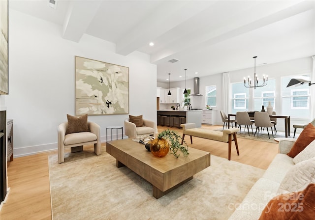 1912 St John St, Charlotte, NC 28216 - living area featuring light wood-type flooring, a chandelier, beam ceiling, and recessed lighting