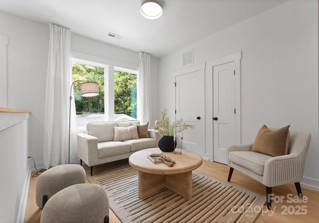 1912 St John St, Charlotte, NC 28216 - living area featuring wood finished floors and baseboards