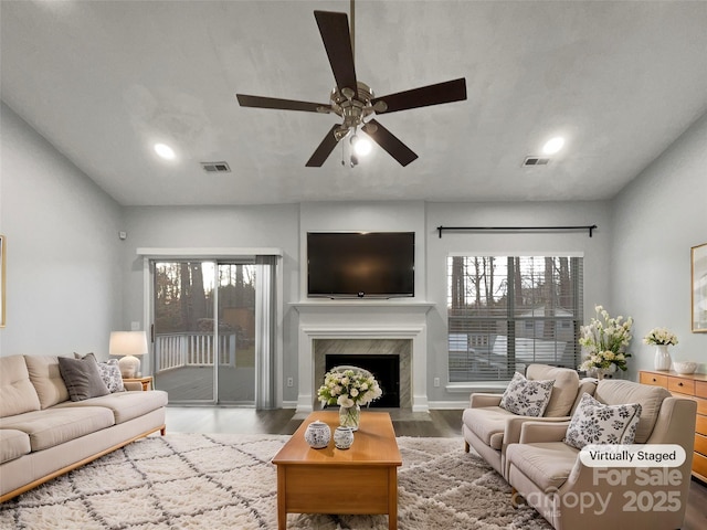 living room featuring hardwood / wood-style floors and ceiling fan