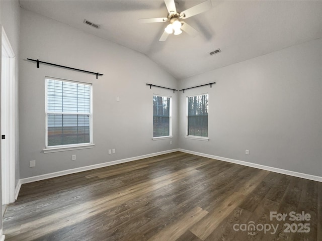 spare room featuring dark wood-type flooring, ceiling fan, and vaulted ceiling