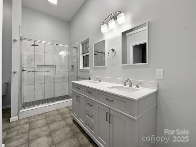 bathroom with vanity and a shower with door