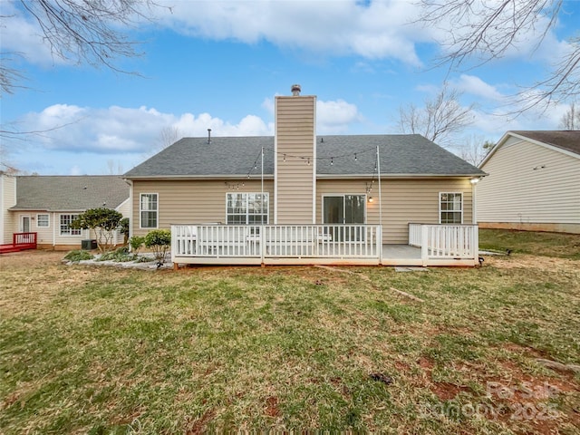 back of house with a yard and a deck