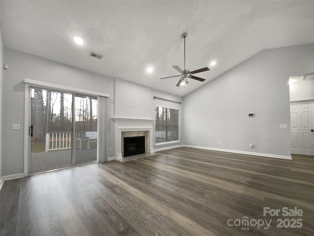 unfurnished living room featuring ceiling fan, high vaulted ceiling, dark hardwood / wood-style floors, and a high end fireplace