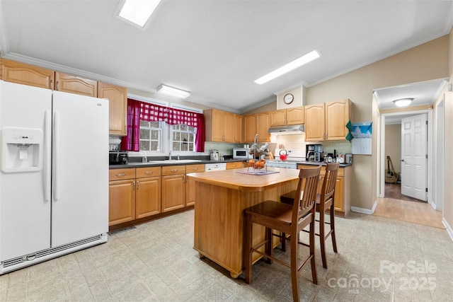 kitchen featuring white appliances, ornamental molding, vaulted ceiling, light floors, and a sink