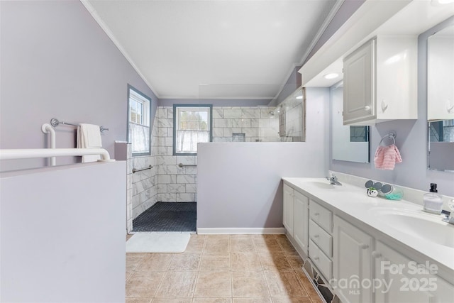 full bathroom featuring double vanity, walk in shower, a sink, and crown molding