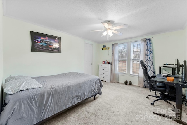 bedroom featuring carpet, crown molding, ceiling fan, a textured ceiling, and baseboards