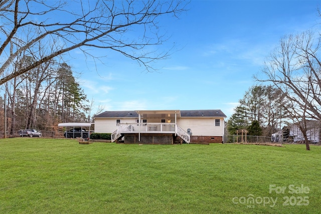 back of property with a yard, crawl space, a wooden deck, and fence