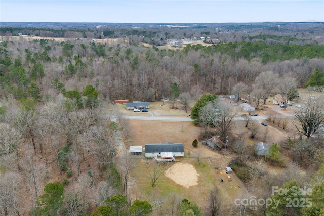 birds eye view of property with a wooded view and a rural view