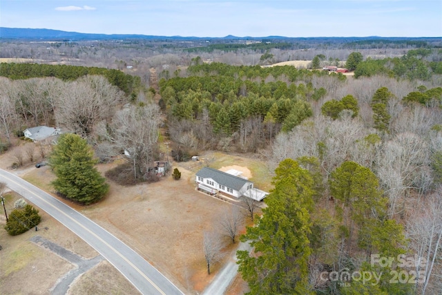 birds eye view of property with a forest view