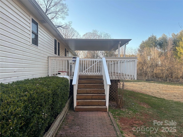 exterior space with stairway, a yard, and a deck